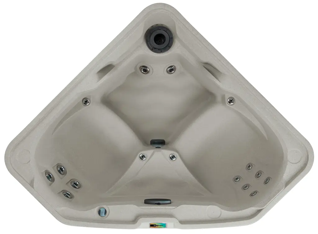 Overhead view of the Fantasy Spas Embrace triangular hot tub in sand color with dual seating and hydrotherapy jets