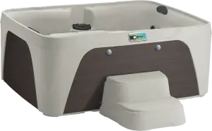Front view of the Fantasy Spas Enamor Premier in Sand shell with Espresso cabinet, showcasing the waterfall feature and ergonomic seating.