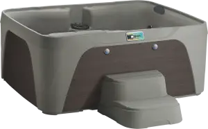 Front view of the Fantasy Spas Enamor Premier in Taupe shell with Espresso cabinet, featuring ergonomic seats and stainless steel jet accents.