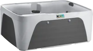 Front view of the Fantasy Spas Enamor Premier in Arctic White shell with Charcoal cabinet, featuring waterfall and stainless steel jet accents.