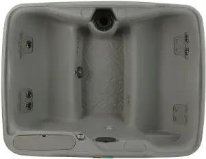Overhead view of the Fantasy Spas Enamor hot tub in Taupe finish, showing four contoured seats including a lounge, 19 stainless steel jets, and a central footwell.