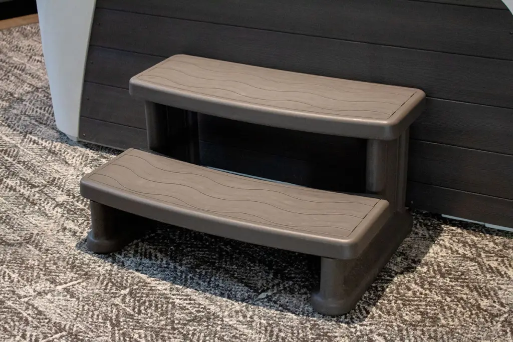 Close-up of Fantasy Premier Spa two-tier steps with textured non-slip surface and durable resin design