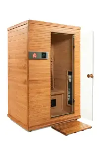 Health Mate Serenity 2 infrared sauna front view with glass door open, showing interior bench seating and infrared heating panels.